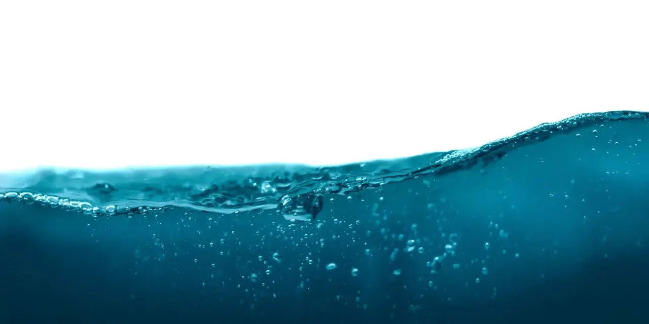 Vague d'eau bleue avec des bulles, rappelant la masse volumique de l'eau.