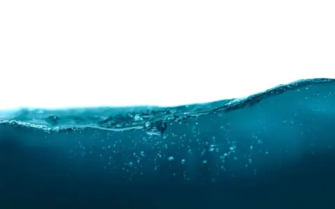 Vague d'eau bleue avec des bulles, rappelant la masse volumique de l'eau.
